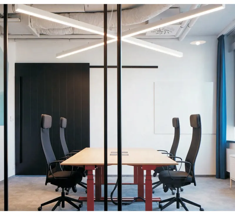 Meeting room with cross-shaped suspended linear LED pendant
