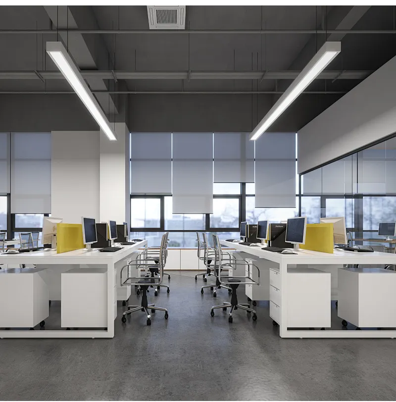 Office interior with suspended linear luminaires above white desks