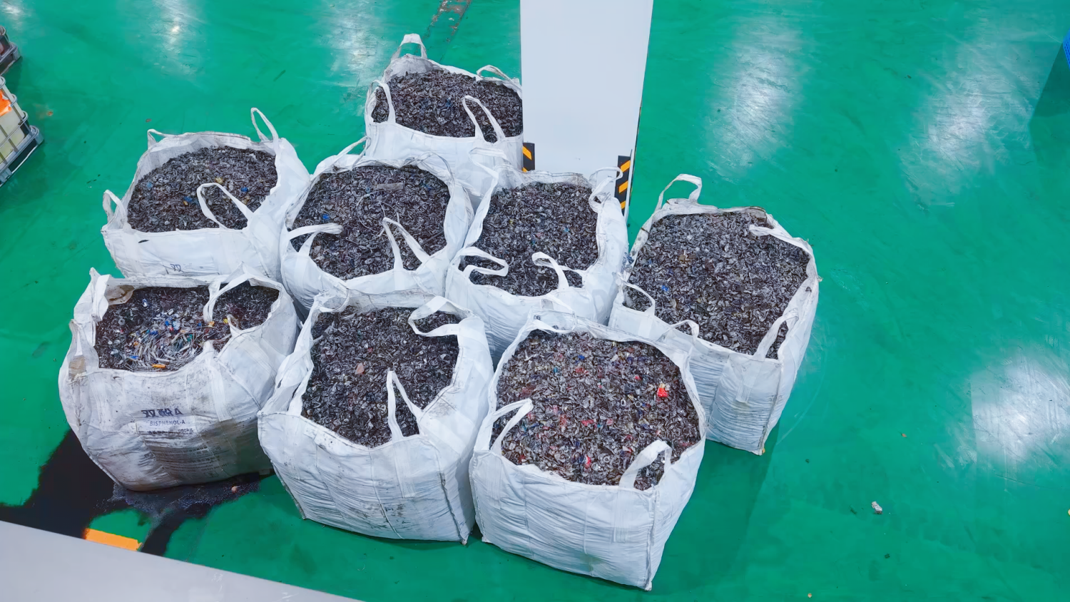 Shredded waste oil filters after size reduction