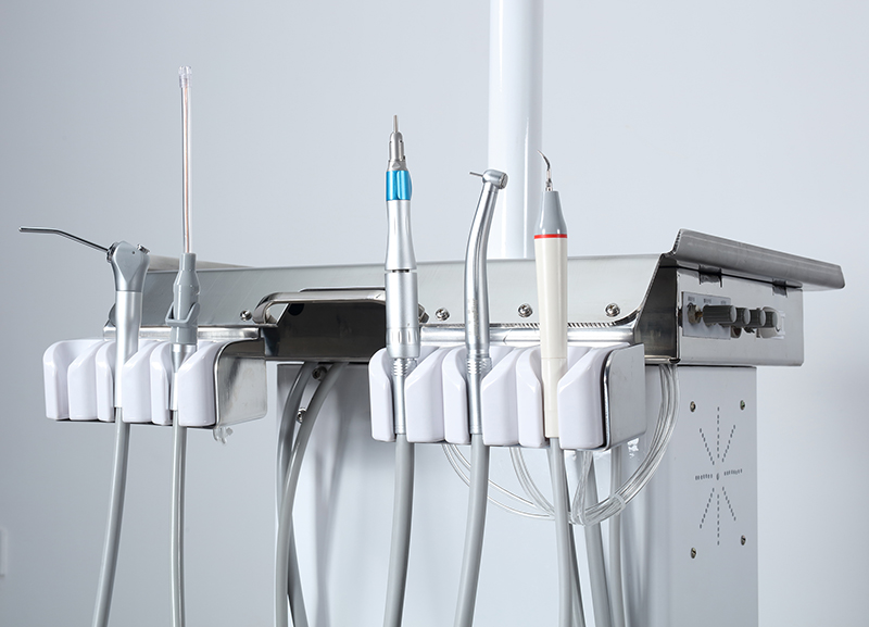Veterinary dental instruments and stainless steel tray on a mobile treatment table