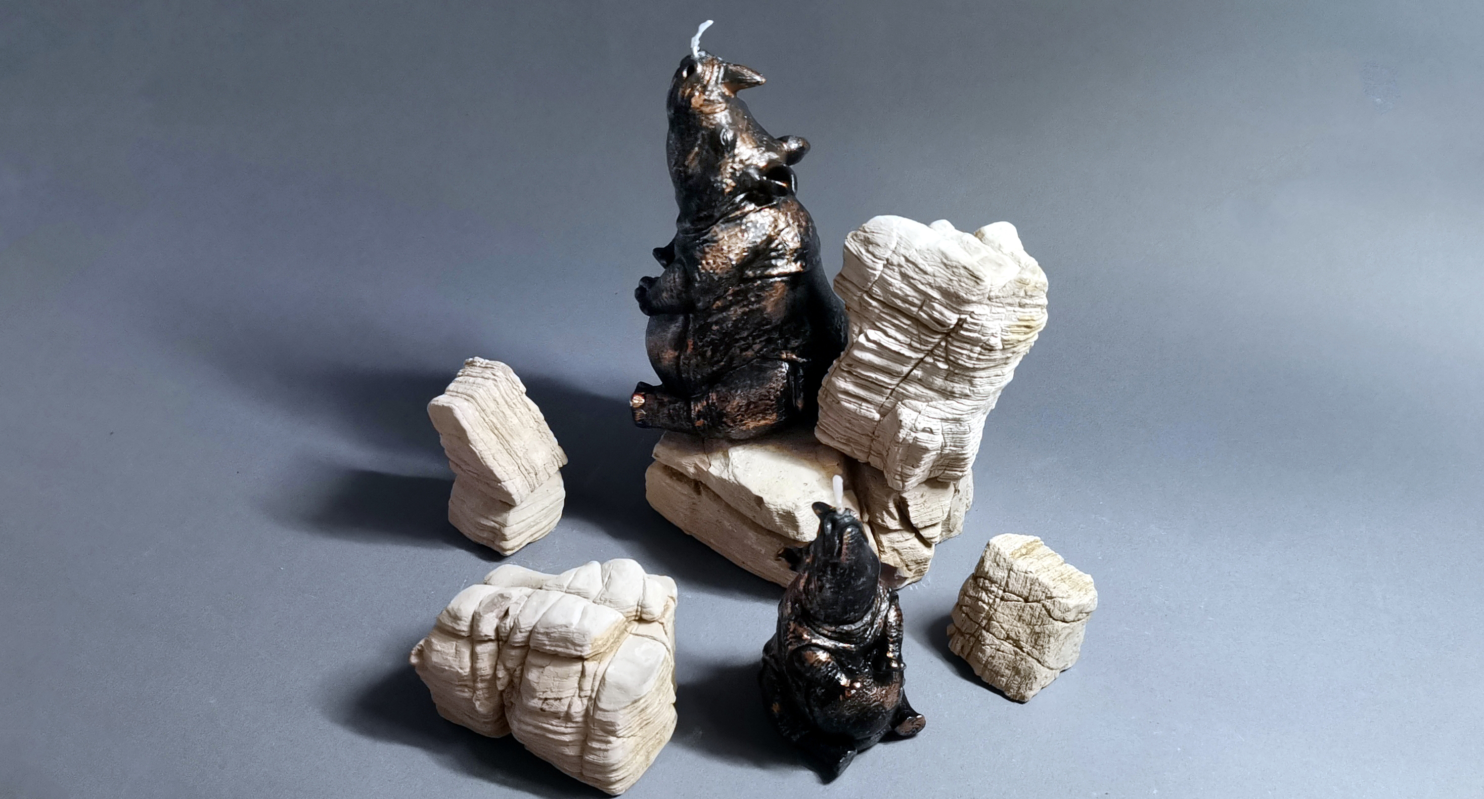 black rhino candles set by white rocks_horizontal