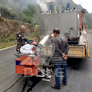 Road marking machine in use
