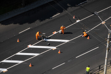 Aerial view of highway thermoplastic line application with ride-on machine