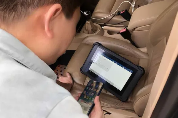 Technician diagnosing five reasons why the ABS light is on using scan tool