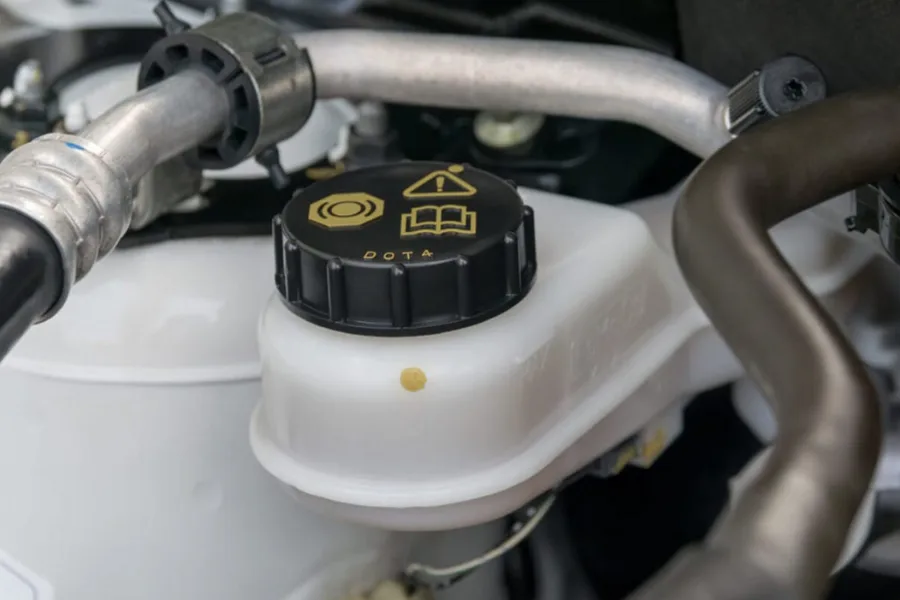 Brake Warning Light Is On: Causes and Solutions showing low brake fluid in master cylinder
