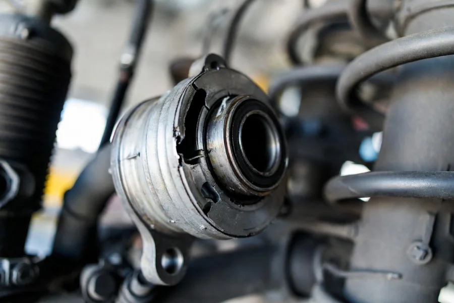 Worn strut bearing showing cracks and wear, contributing to steering issues, suspension problems, and unusual noises.