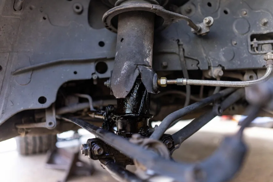 Signs of Suspension Problems and Easy Repair You Can Do Yourself illustrated by visible shock absorber wear and oil leakage