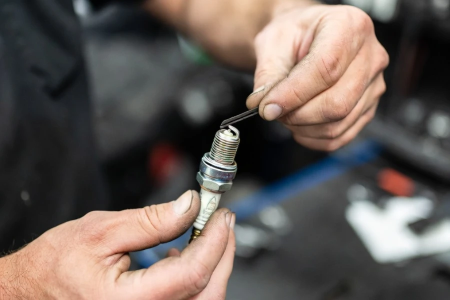 checking spark plug gap during spark plug cleaning and maintenance
