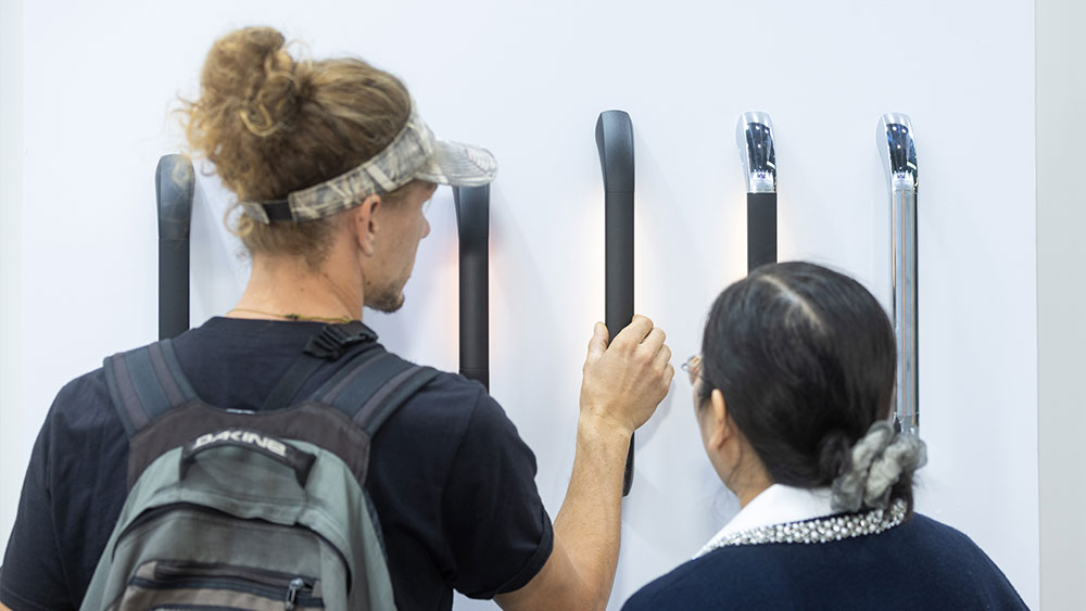 RV hardware product presentation and customer interaction at Caravan Salon Düsseldorf