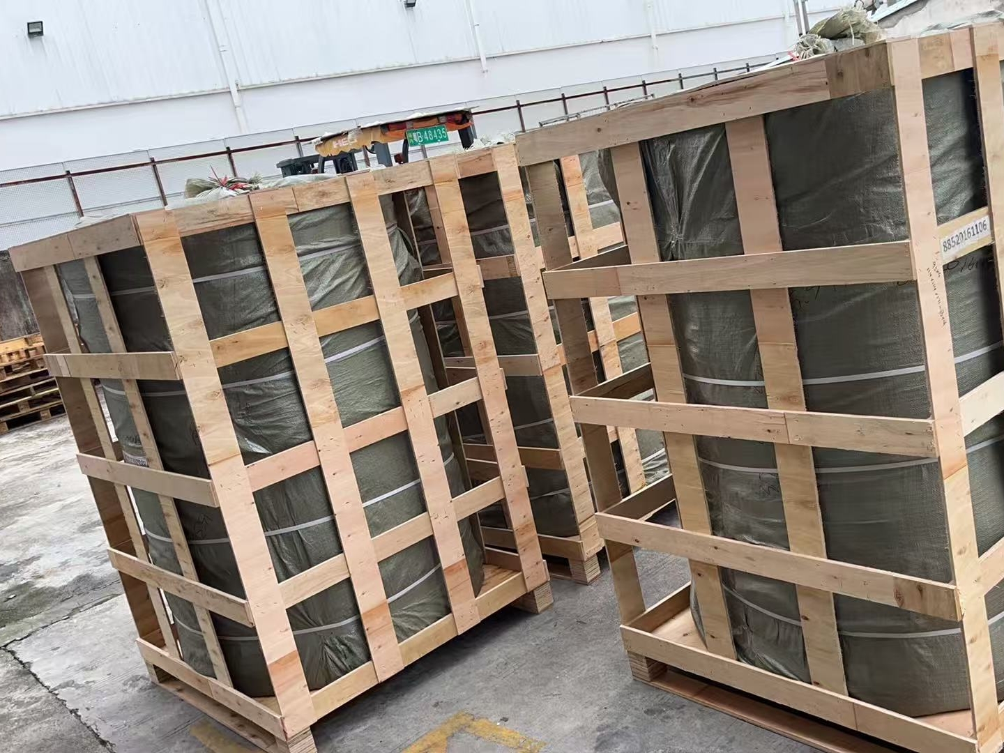 QT MAT order being loaded for shipment with reinforced wooden crates