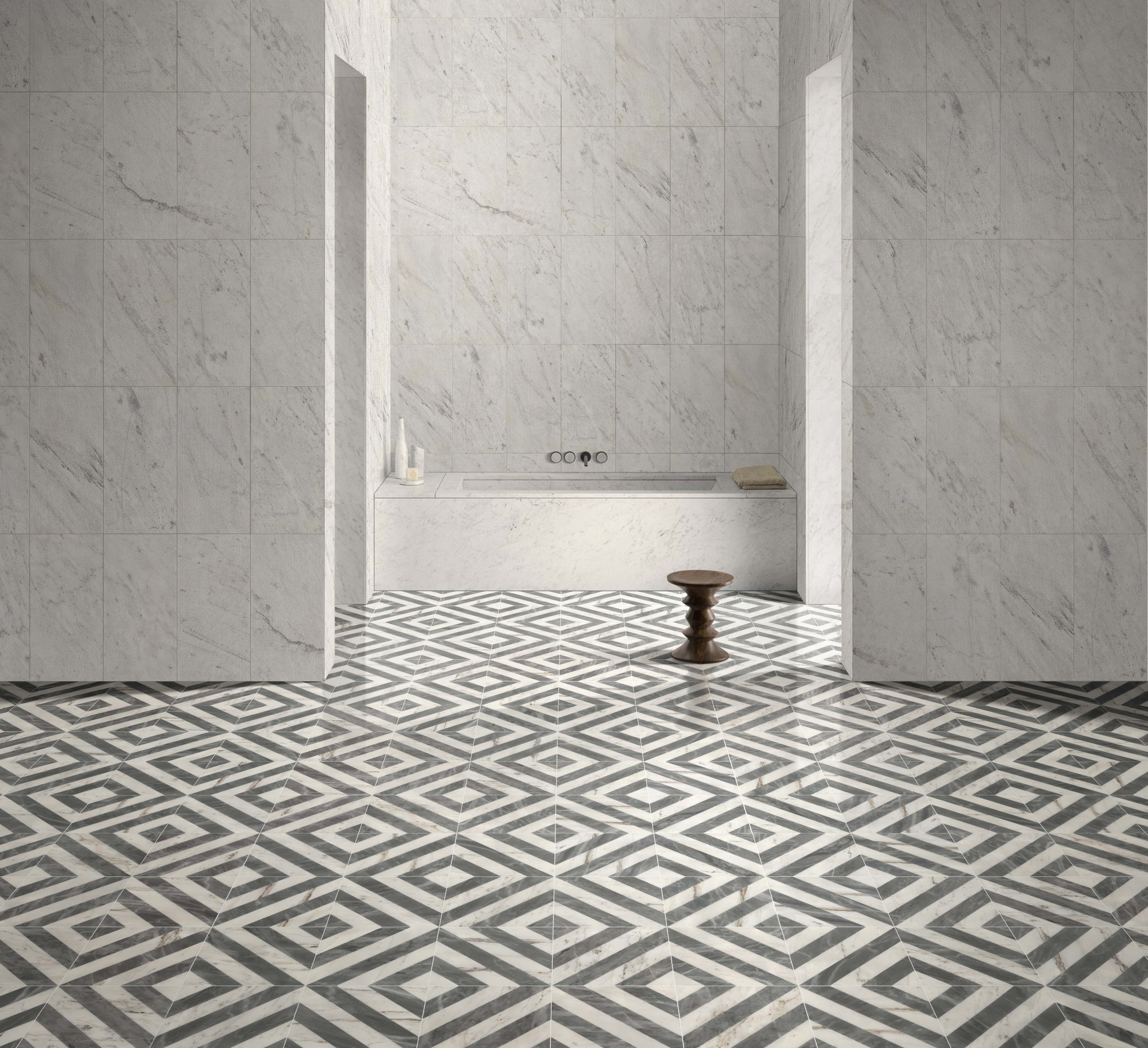 Minimalist bathroom setting highlighting 12x12 geometric waterjet marble floors complementing 12x24 Snow Mountain White FS textured natural stone wall tiles.