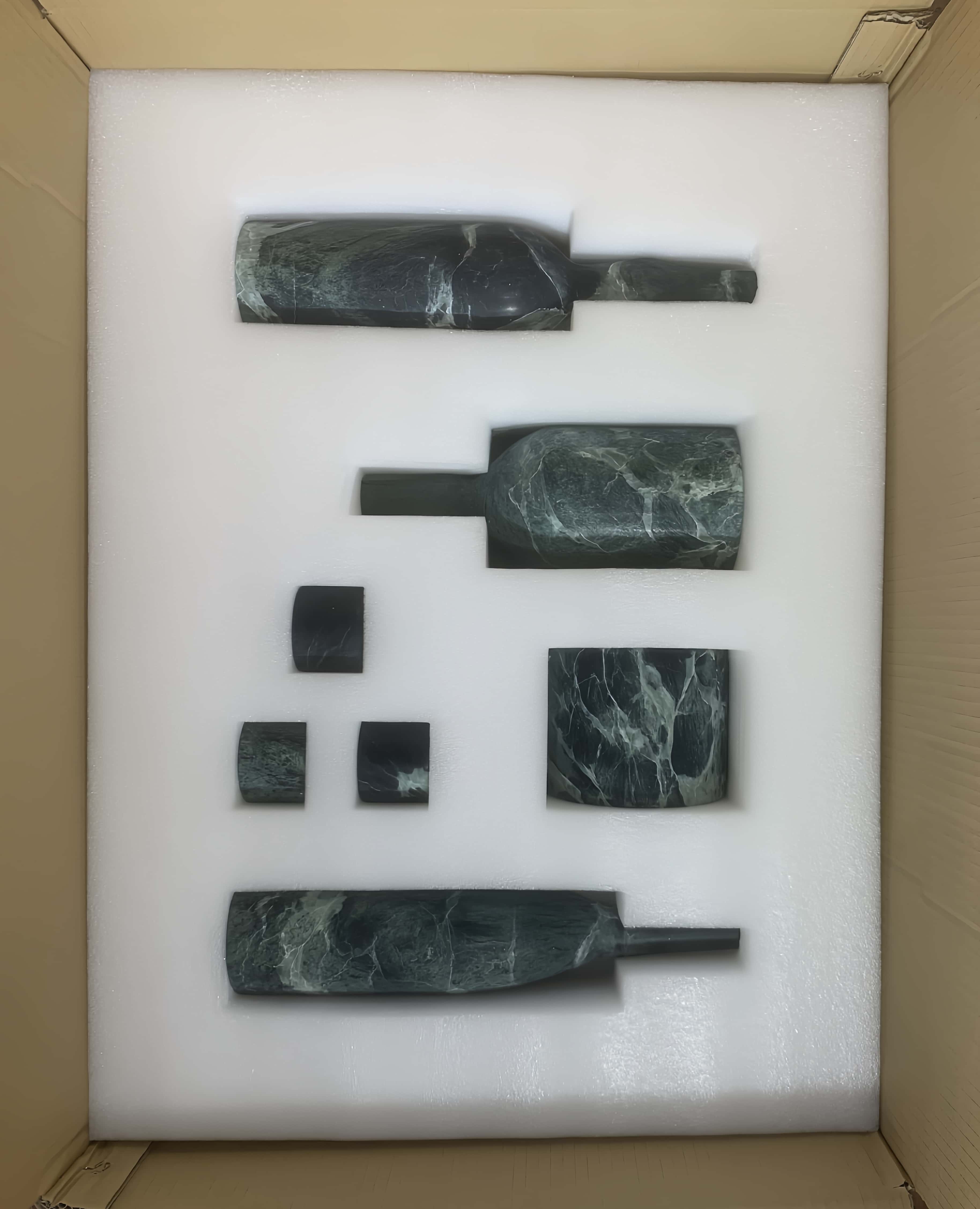 Custom-cut, damage-proof foam packaging securing the 7-piece natural marble home decor set to guarantee safe and pristine arrival.