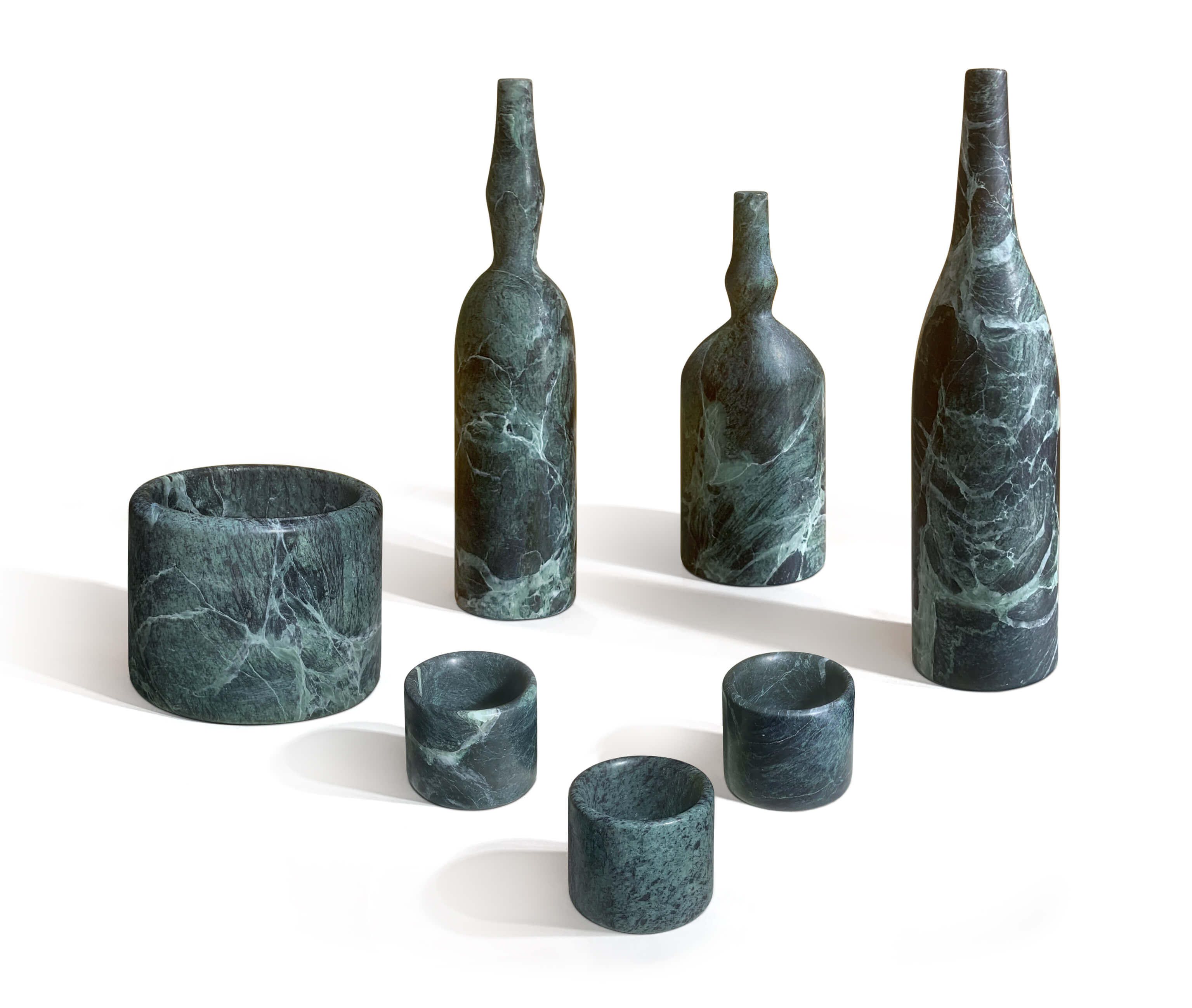 7-Piece Diamond Green natural marble home decor set featuring dark green sculptural vases, a diffuser holder, and tealight holders on a white background.