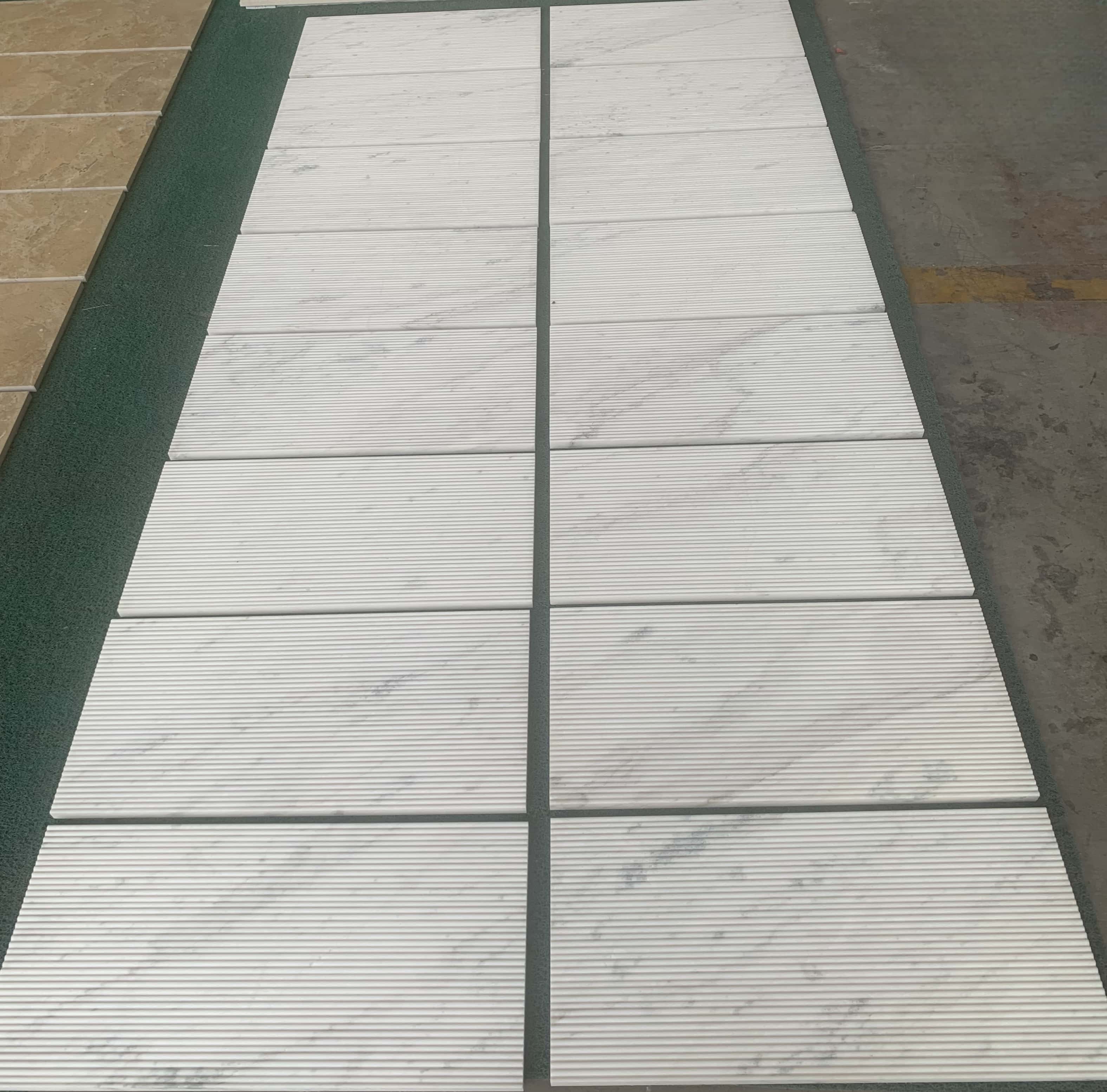 Premium Snow Mountain White fluted marble tiles displayed in bulk, ready for fast shipping from our US warehouse.