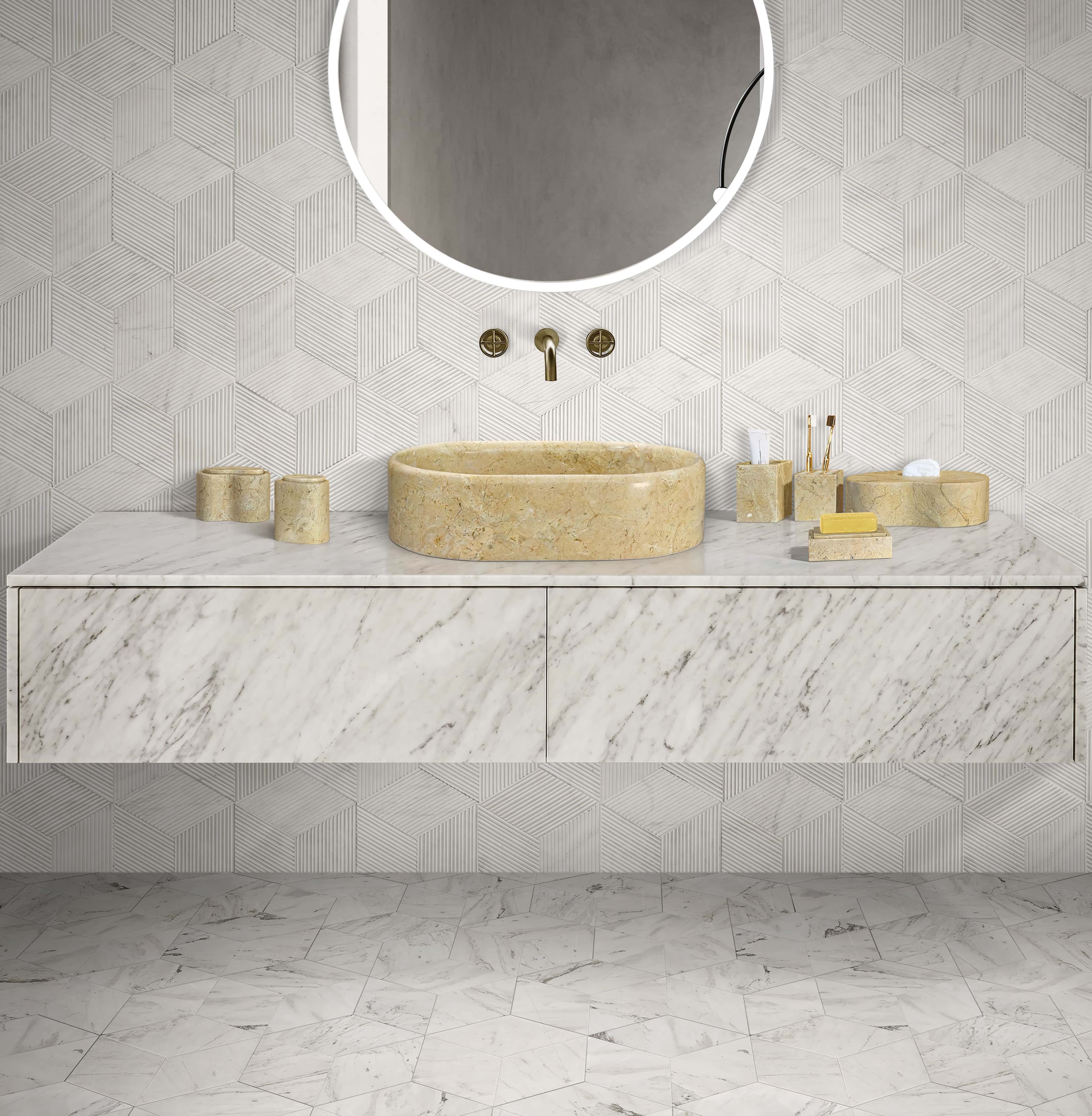 Hyatt Gold marble vessel sink with Snow Mountain White hexagon textured wall tile, polished floor tile, and coordinated honed marble accessory set.