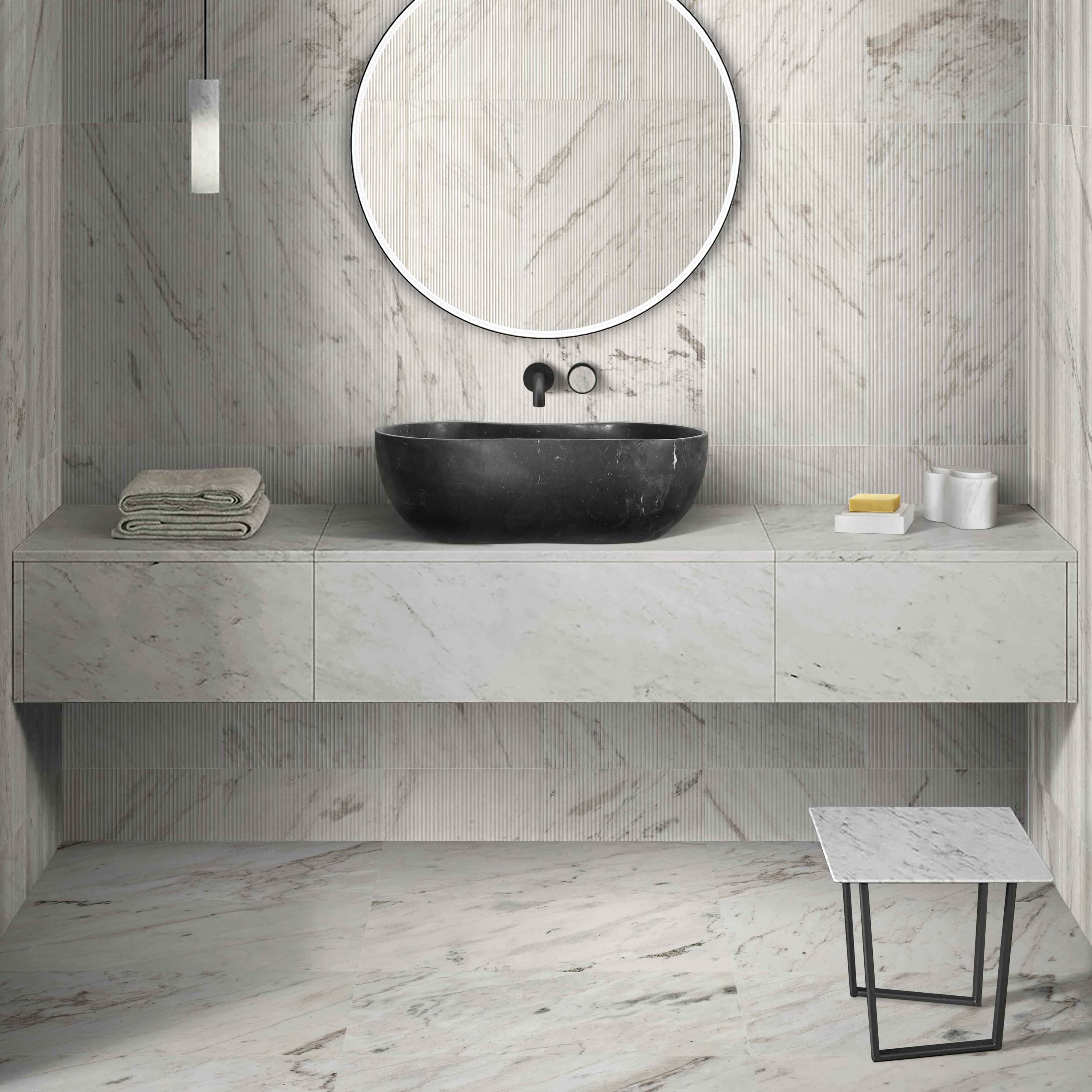 An Olive Black marble wave vessel sink with Snow Mountain White marble accessories on a marble top, featuring Snow Mountain White polished floor tiles and OL textured wall tiles.