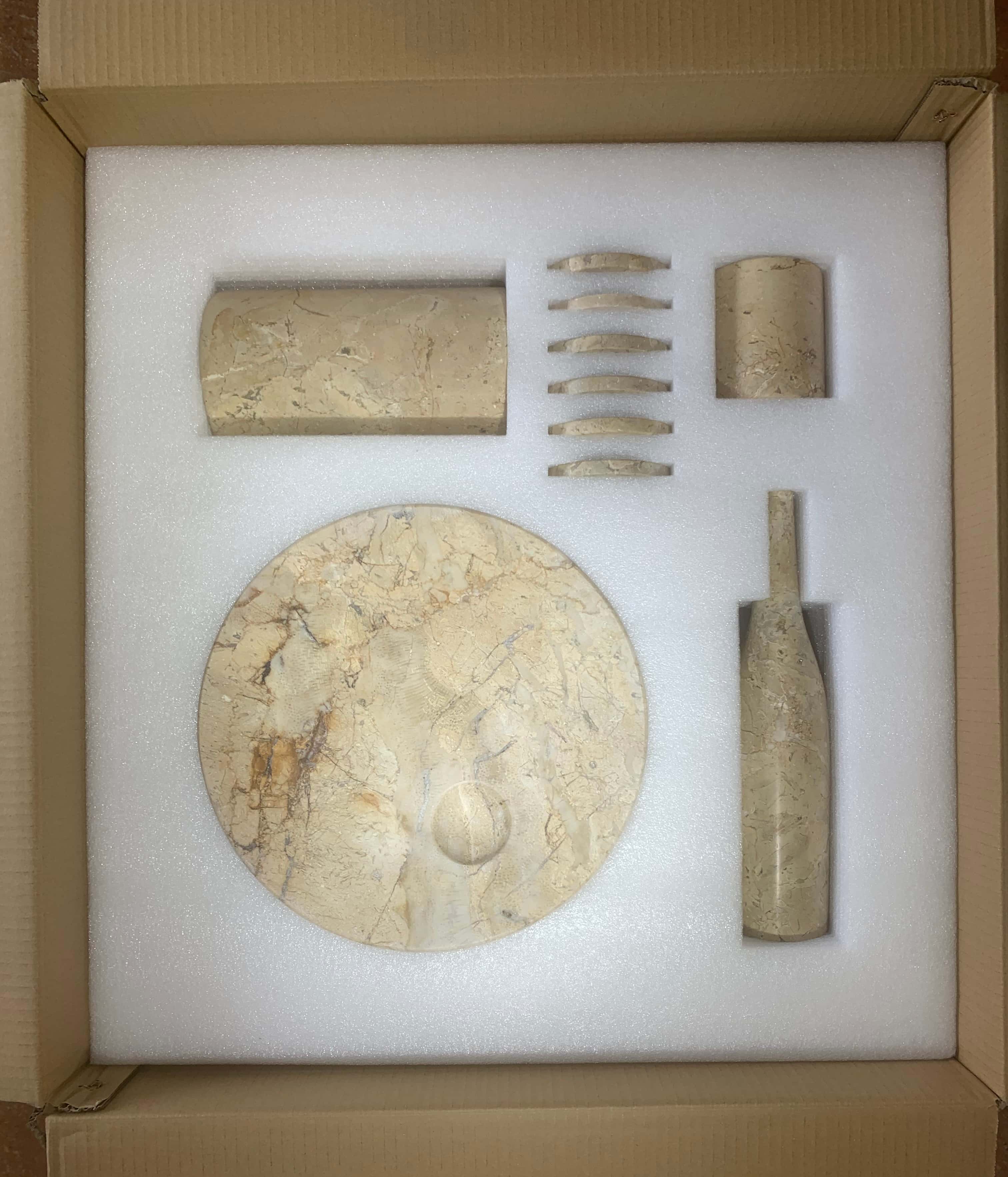 Custom protective foam packaging inside the box for the Hyatt Gold natural marble 10-piece set.