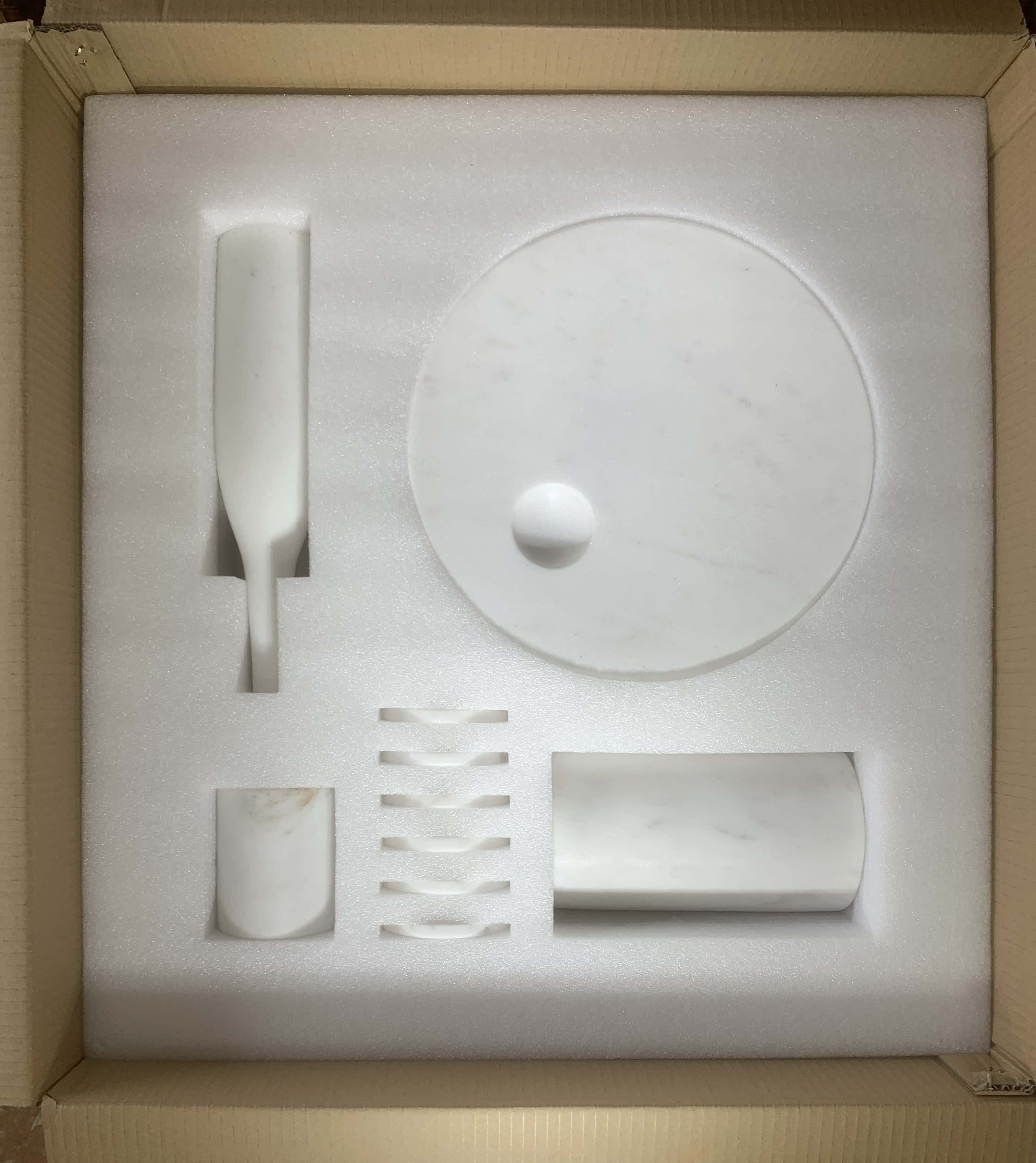 Custom protective foam interior packaging for 10-piece Snow Mountain White marble decor set.