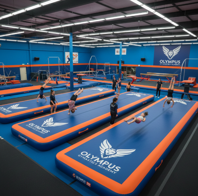 Customized inflatable gymnastics mats with a gym’s logo and colors, enhancing brand identity.