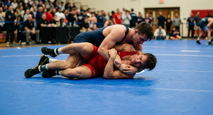 Athletes safely grappling on a uniform, high-quality inflatable wrestling mat