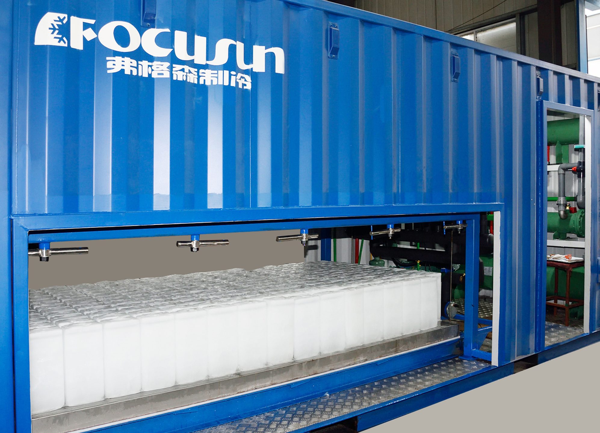 Focusun fully automated containerized block ice machine built inside a standard ISO shipping container using direct refrigeration plates to eliminate brine tanks.