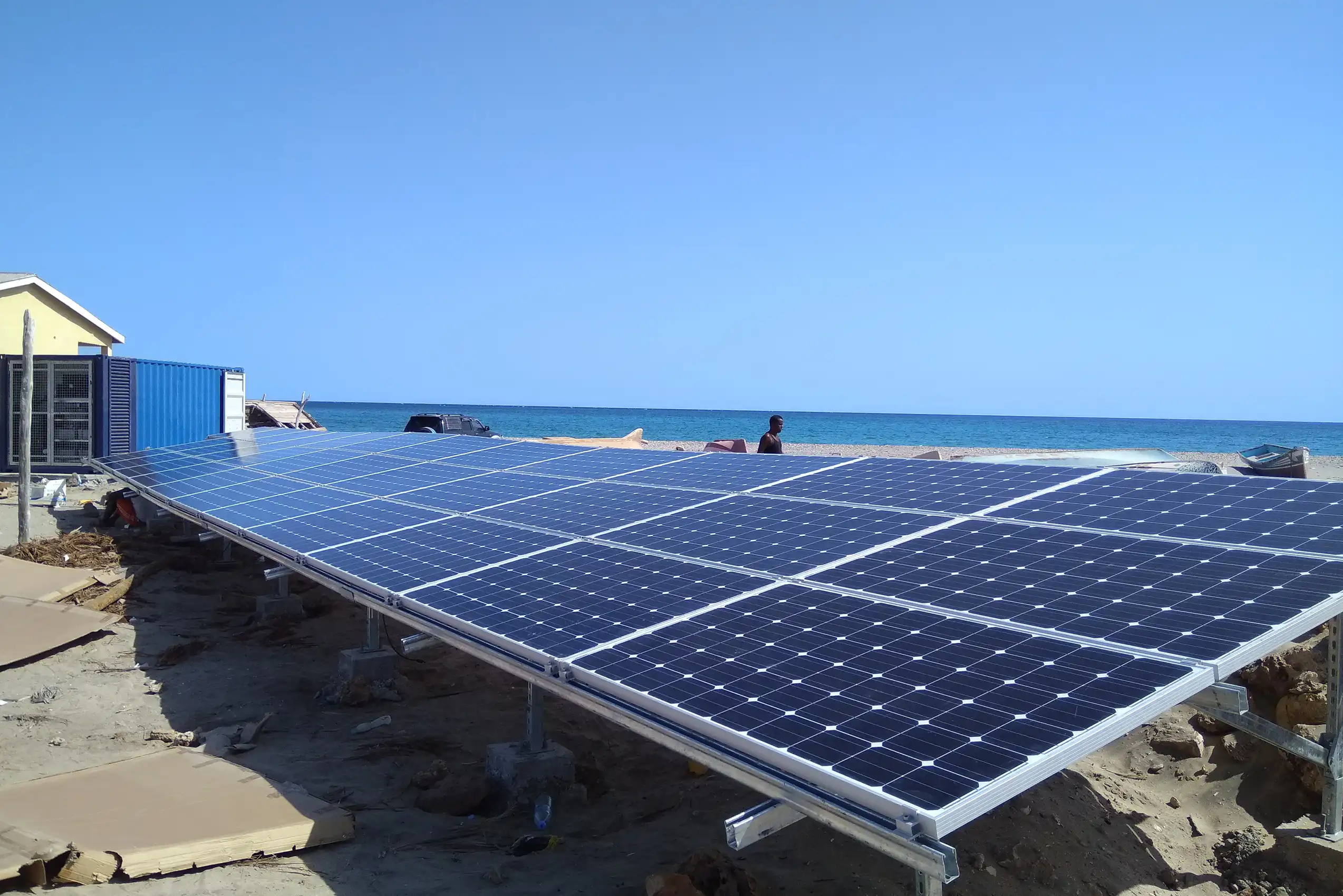 Rooftop PV solar panel array powering refrigeration units and battery bank