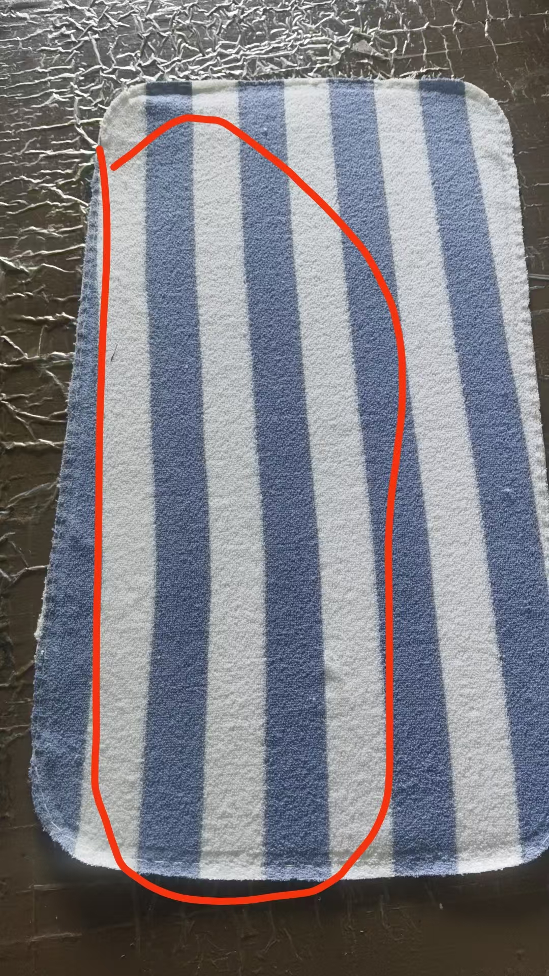 Blue and cream striped terry cut panel with visible stripe skew and the factory's red inspection mark