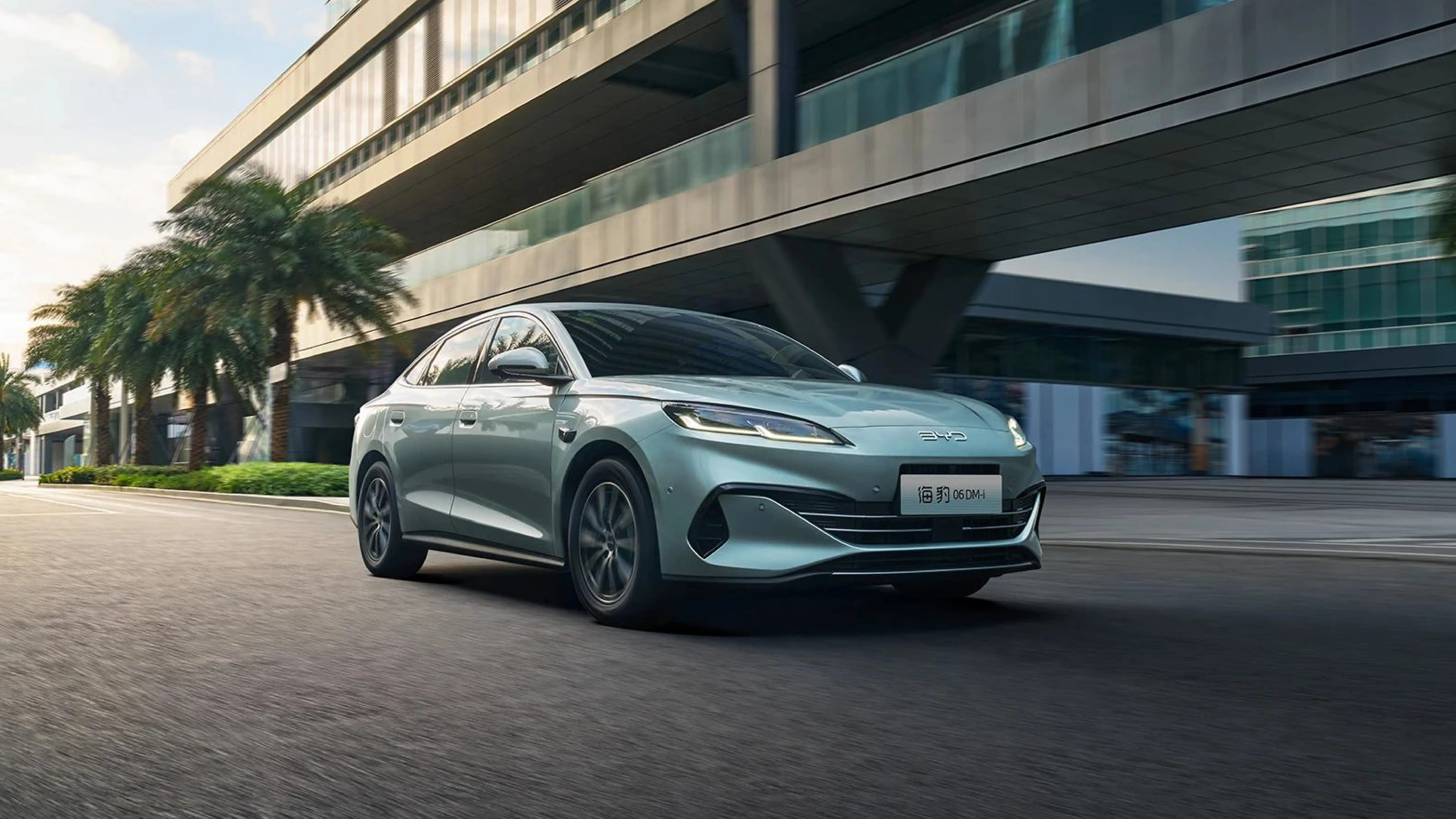 A sleek Chinese-made electric vehicle drives through a modern city, representing the innovation of China's auto industry.