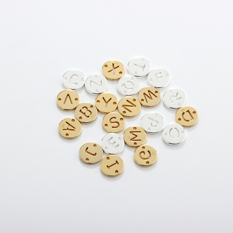 925 sterling silver alphabet charms displayed as round coin letter charms