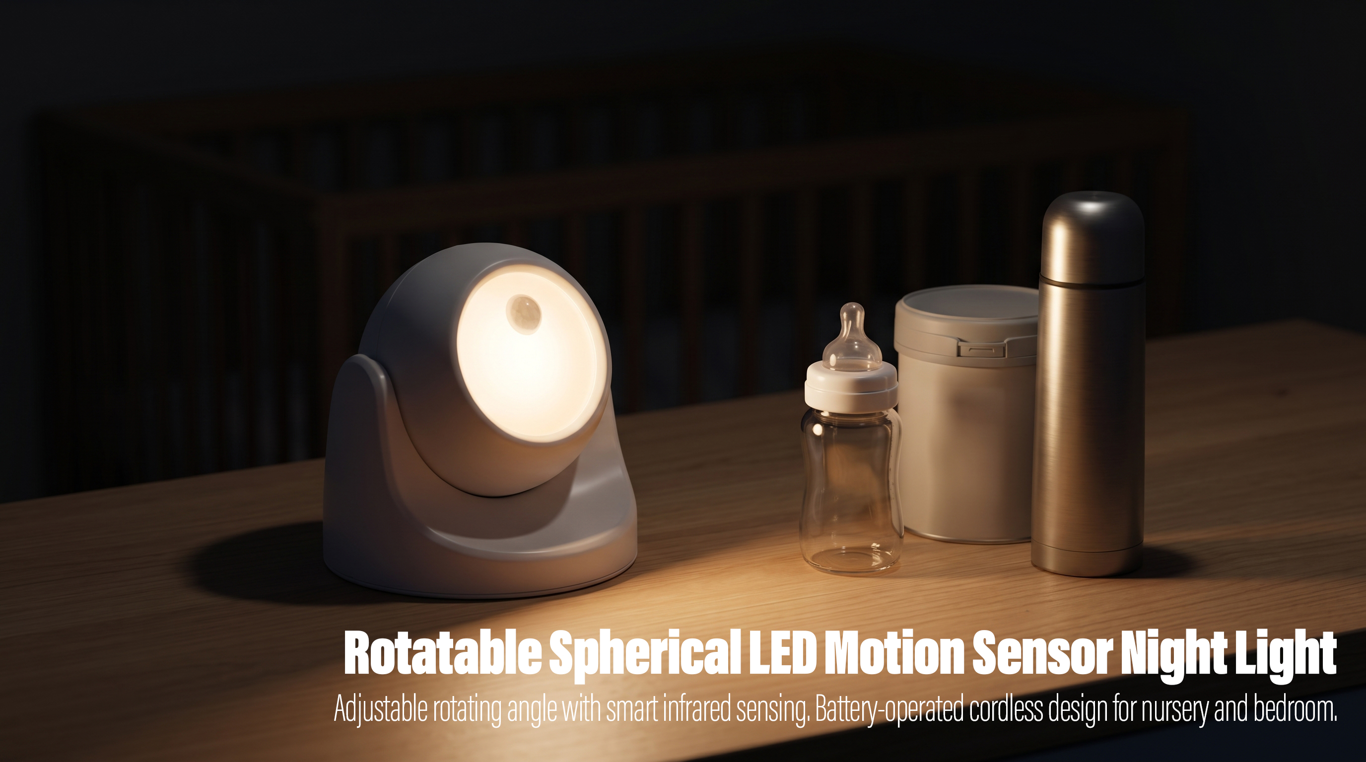 An illuminated white spherical rotatable motion sensor LED light on a wooden table, casting a warm glow next to a baby bottle, a formula container, and a thermos with a blurred crib in the background.