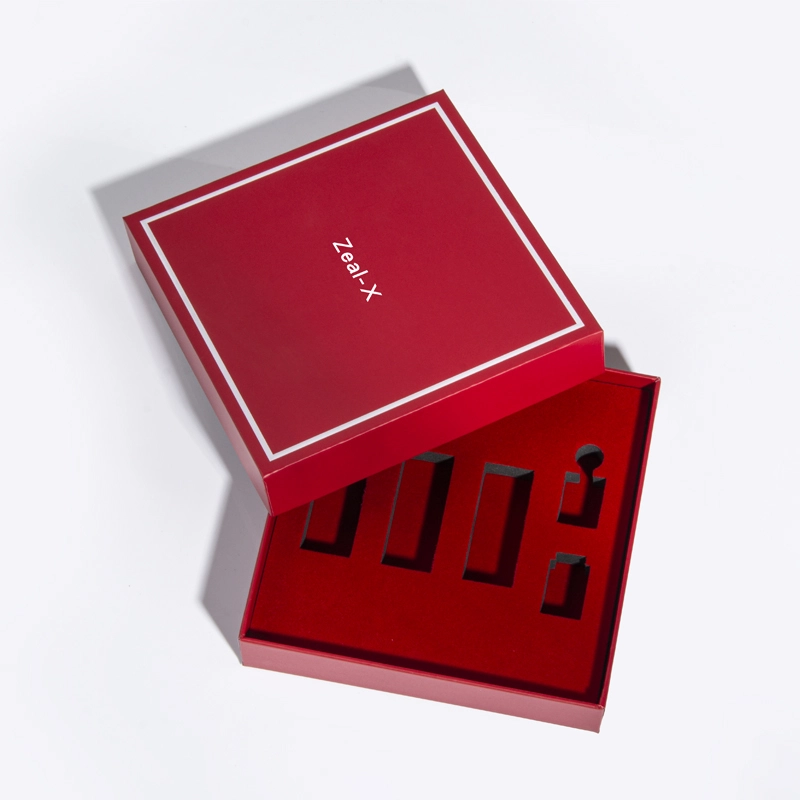 Red two-piece cosmetic gift box with a white-bordered lid and fitted insert compartments for assorted makeup products