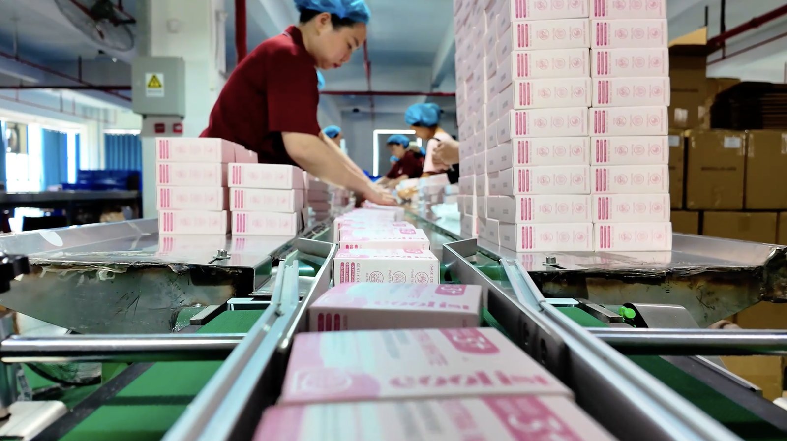 Printed pink boxes on a packaging line