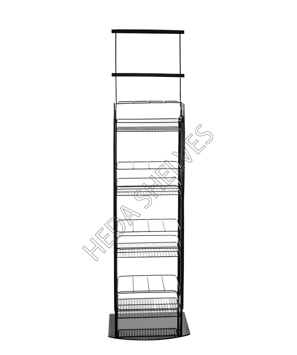 Original front factory photograph of HEDA No.00191 bottled goods display stand showing four open black wire trays with front retaining rails, narrow metal uprights, extended double-bar sign frame and rectangular floor base