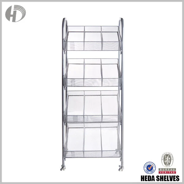 Original front-view HEDA No.00192 steel basket display fixture with four stacked mesh basket tiers, internal compartment dividers, rounded tubular uprights and caster wheels