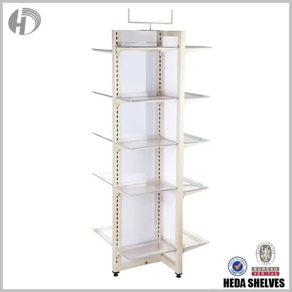 Original HEDA No.00195 four-sided retail display stand showing a cream-colored steel center frame, transparent acrylic shelves projecting in multiple directions, top sign holder and small black base feet