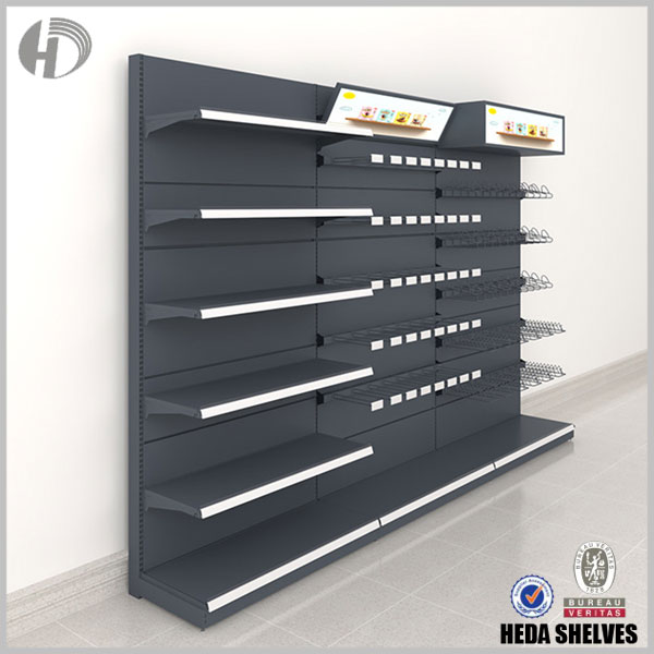 Original HEDA black commercial display shelving illustration with flat metal shelves on one section, wire hanging accessories on the adjoining section and angled overhead advertising panels