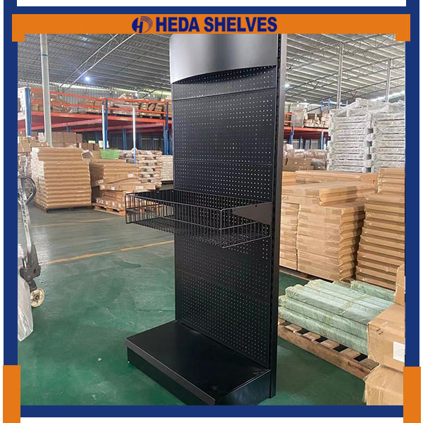 Original HEDA PDS04 hardware display stand photographed at an angle, featuring a tall black round-hole pegboard, one projecting black wire basket, curved upper header and open floor-level base