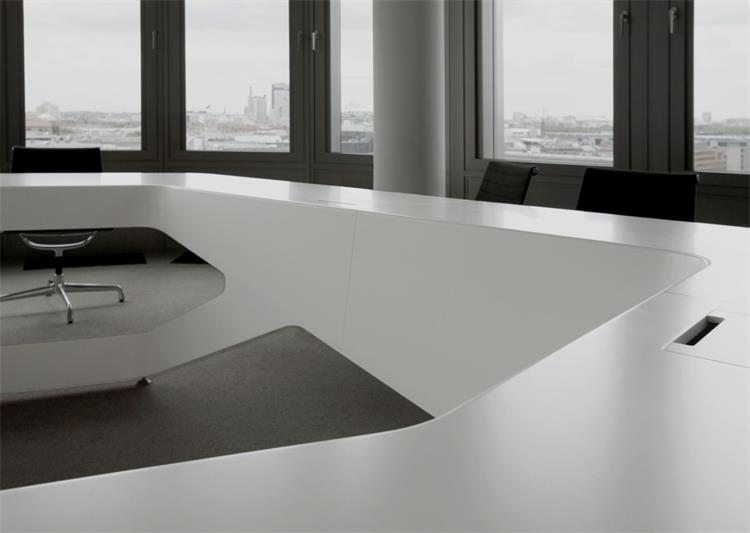 large many people white corian meeting table