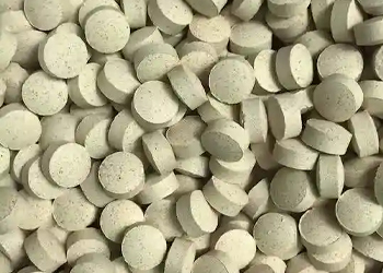 Light green round polished tablets made with a tablet polishing machine
