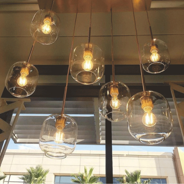 Mid Century Modern Glass Jar Pendant Light in Brass Over Kitchen Island Dining Table and Breakfast Bar Lighting