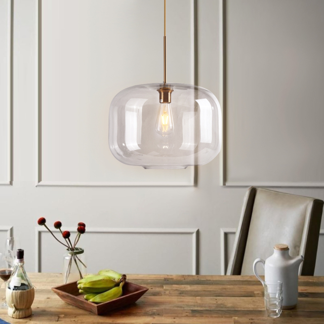 Mid Century Modern Glass Jar Pendant Light in Brass Over Kitchen Island Dining Table and Breakfast Bar Lighting
