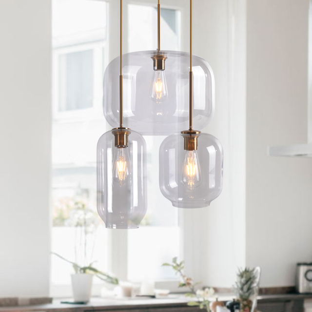 Mid Century Modern Glass Jar Pendant Light in Brass Over Kitchen Island Dining Table and Breakfast Bar Lighting