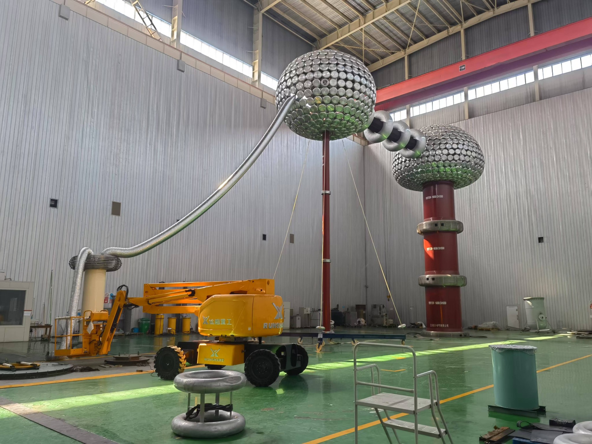 Technicians working on transformer bushing assemblies