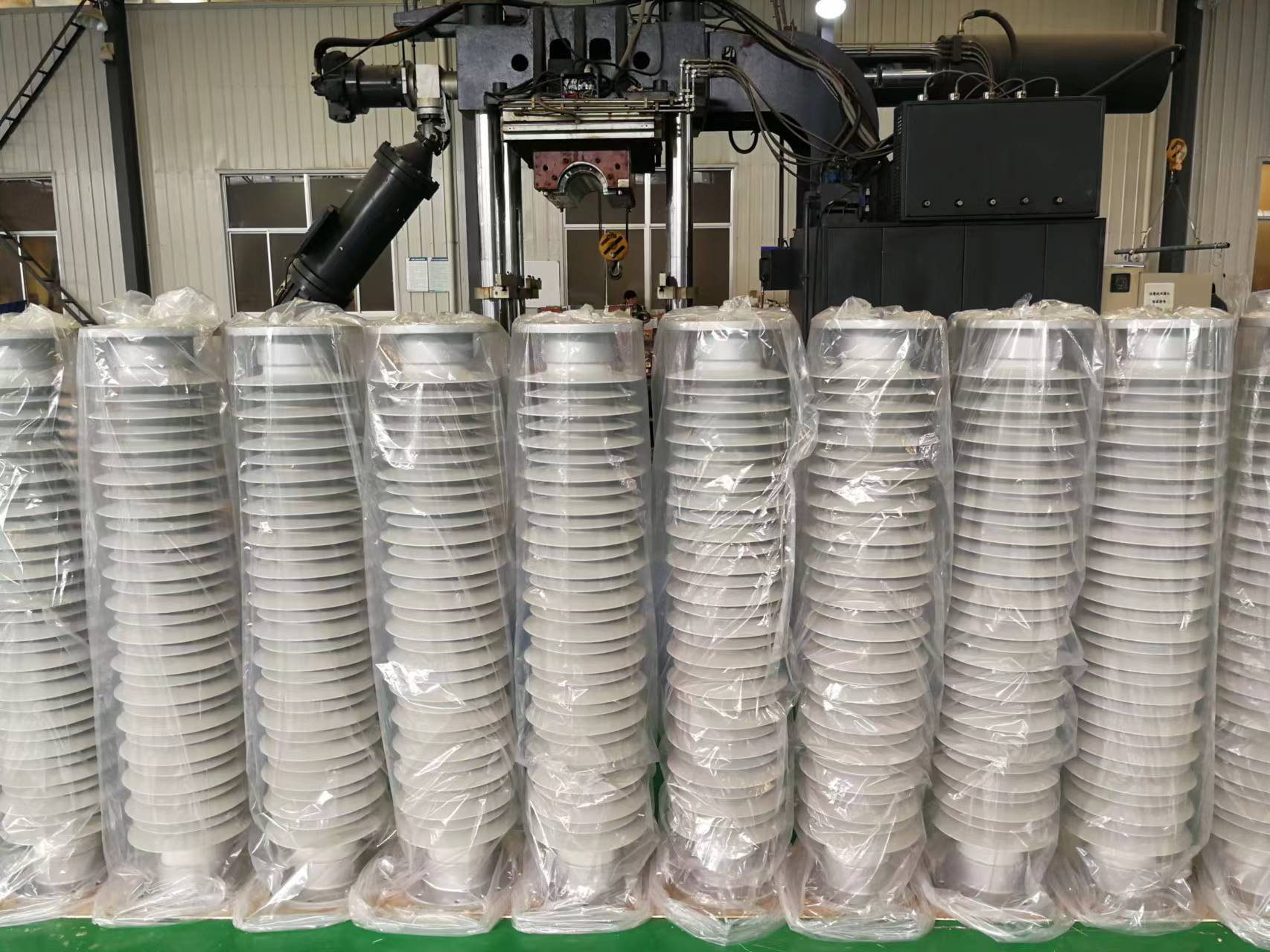 Rows of protected porcelain bushing components in a workshop