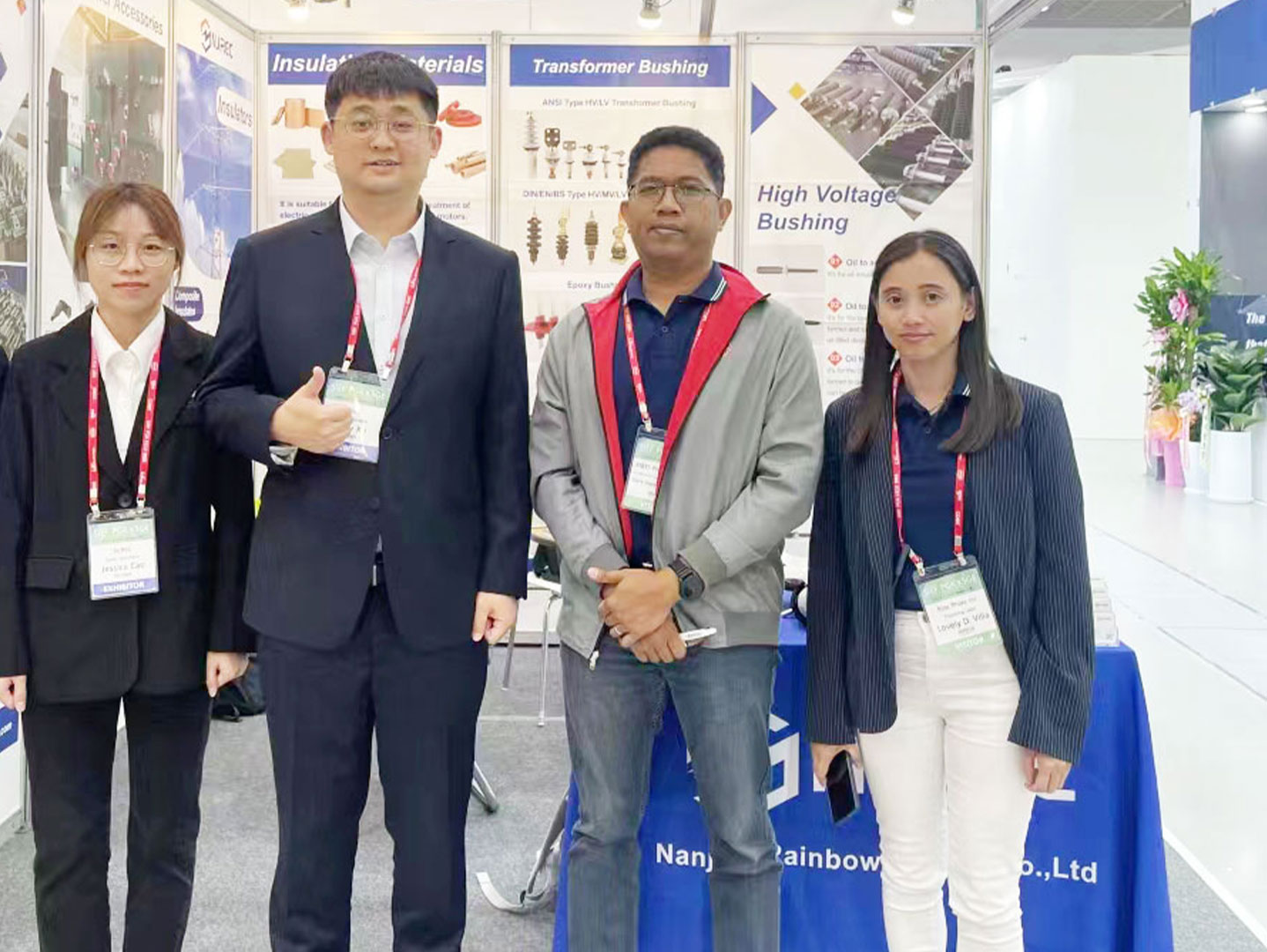 NJREC representatives and a visitor at a power equipment exhibition