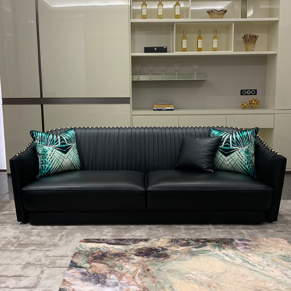 Black leather sofa with metal accents