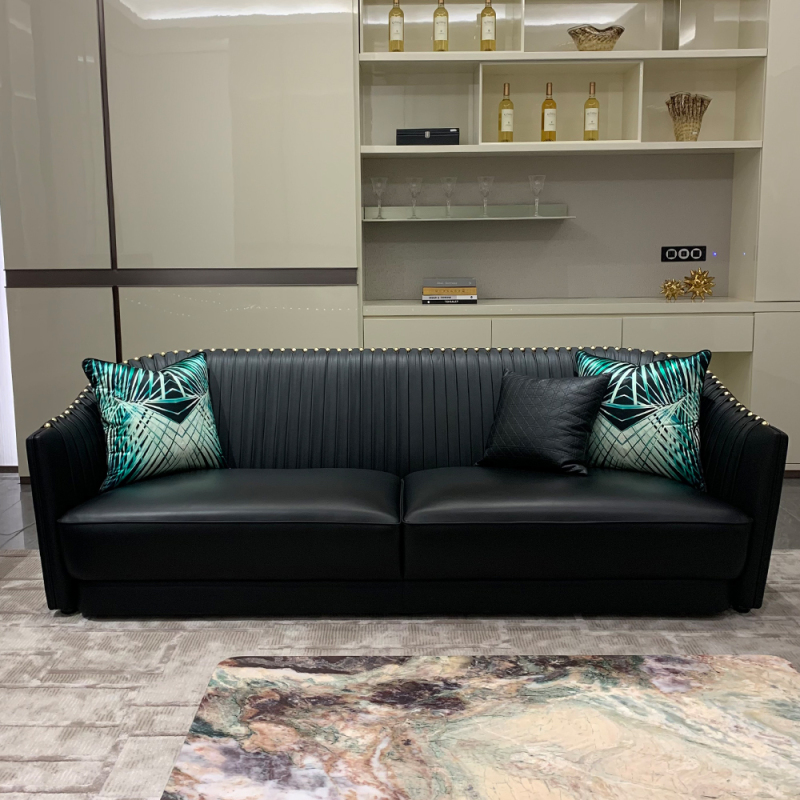 Black leather sofa with metal accents