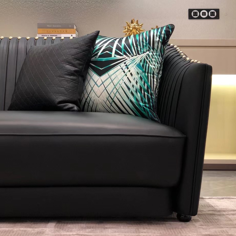 Black leather sofa with metal accents