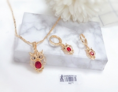 Golden owl holding ruby ​​necklace and earrings