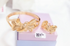 Bow style glossy gold bangle ring